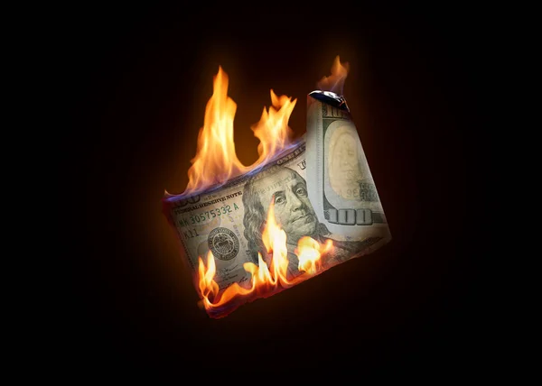 One hundred dollar banknote burning on black background