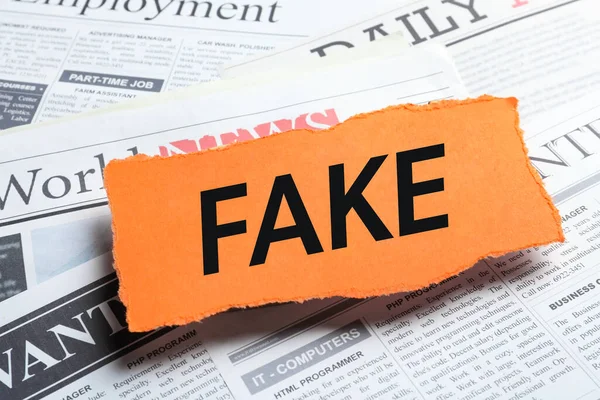 Orange Paper Piece Word Fake Pile Newspapers Closeup — Foto Stock