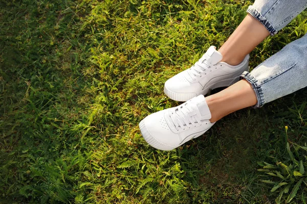 Woman Jeans White Shoes Relaxing Green Grass Closeup Space Text — 스톡 사진