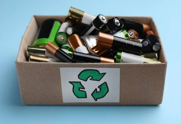 Used Batteries Cardboard Box Recycling Symbol Light Blue Background Closeup — Stockfoto