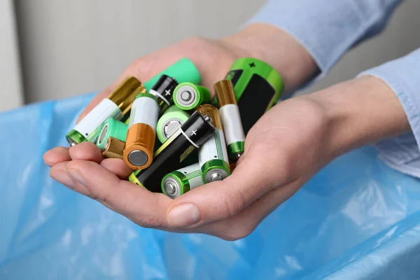 Woman Holding Many Used Electric Batteries Her Hands Closeup — ストック写真