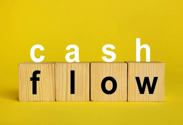 Phrase Cash Flow Made Letters Wooden Cubes Yellow Background — Stockfoto