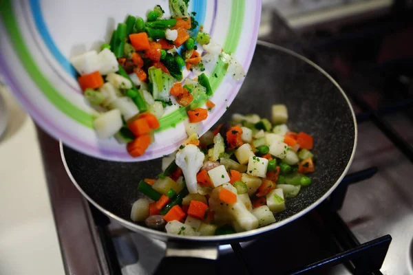 Pouring Mix Fresh Vegetables Frying Pan Kitchen Stove Closeup — Stock fotografie