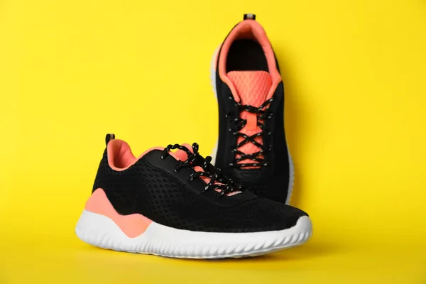 Pair Stylish Sport Shoes Yellow Background — стоковое фото