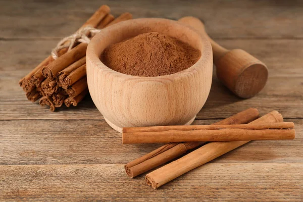 Aromatic Cinnamon Powder Mortar Sticks Pestle Wooden Table — Stock Photo, Image