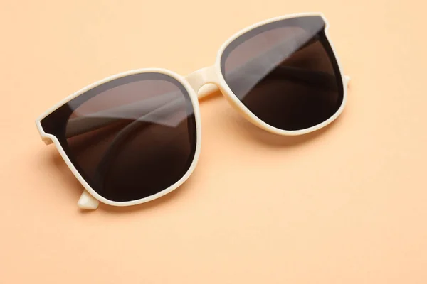 New Stylish Elegant Sunglasses Beige Background Closeup — Stock fotografie
