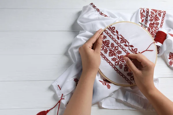 Woman Embroidering Shirt Red Thread White Wooden Table Top View — Fotografia de Stock