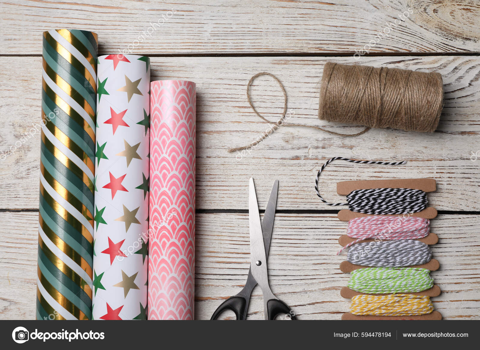 Different Colorful Wrapping Paper Rolls Scissors Threads White Wooden Table  Stock Photo by ©NewAfrica 594478194