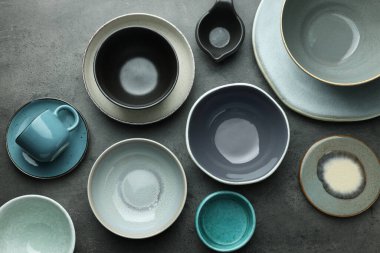 Stylish empty dishware on grey table, flat lay