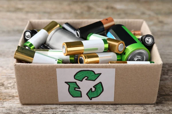 Used Batteries Cardboard Box Recycling Symbol Wooden Table Closeup — ストック写真