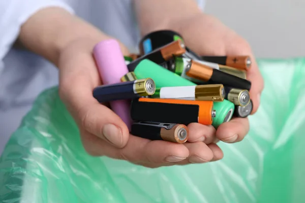 Woman Holding Many Used Electric Batteries Her Hands Closeup — ストック写真