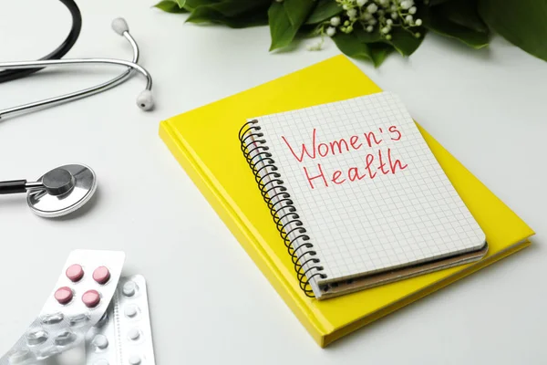Notebook Text Women Health Pills Stethoscope White Table — ストック写真