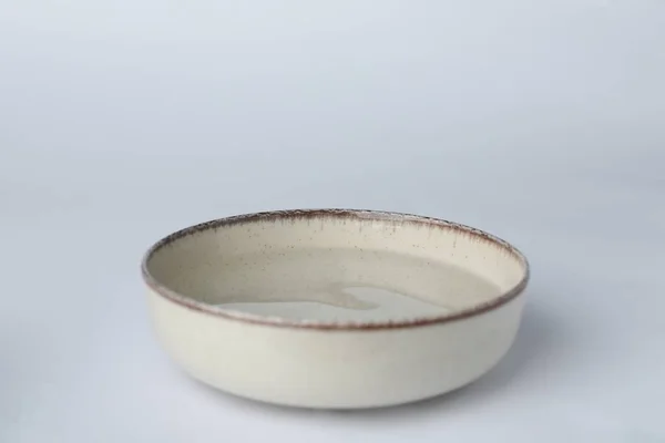 Beige Bowl Full Water White Background — Stok fotoğraf