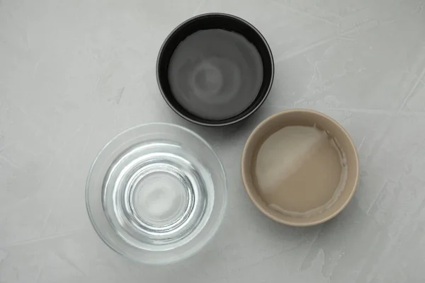 Bowls Water Grey Table Flat Lay — стоковое фото