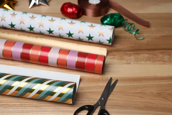 Colorful Wrapping Paper Rolls Scissors Ribbons Wooden Table — Foto Stock