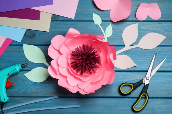 Beautiful Paper Flower Scissors Hot Glue Gun Blue Wooden Background — Stockfoto