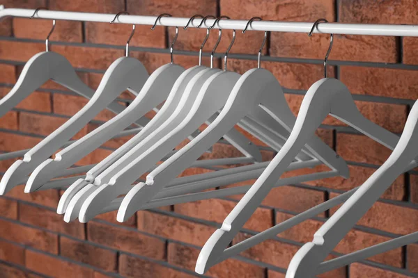 White Clothes Hangers Rail Red Brick Wall — Fotografia de Stock