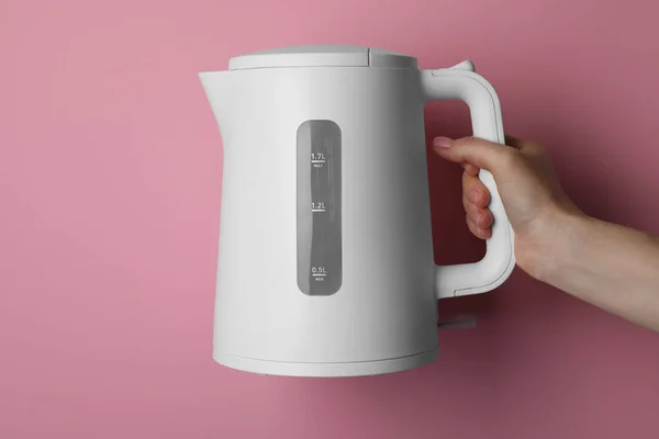 Woman Holding Modern Electric Kettle Pink Background Closeup — 图库照片