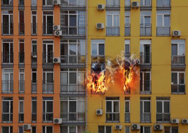 Modern buildings engulfed in flames. Fire safety violations