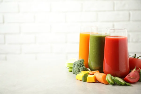 Different Tasty Juices Fresh Ingredients Grey Table Brick Wall Space — Stock Photo, Image