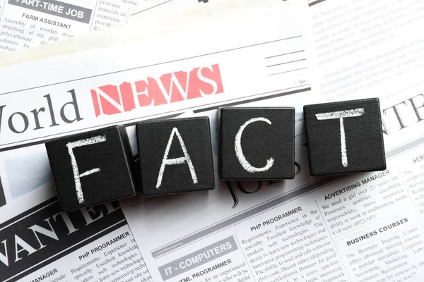 Word Fact Made Black Cubes Pile Newspapers Flat Lay —  Fotos de Stock