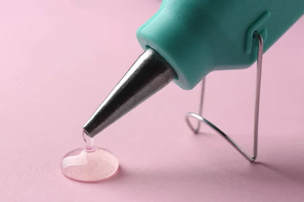 Melted Glue Dripping Out Hot Gun Nozzle Pink Background Closeup — Foto Stock