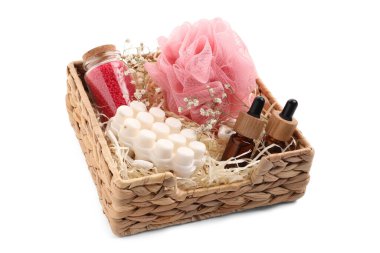 Spa gift set of different luxury products in wicker basket on white background