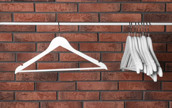 White Clothes Hangers Rail Red Brick Wall — 图库照片