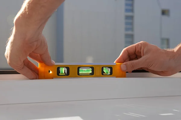 Worker Using Bubble Level Plastic Window Installation Indoors Closeup — Stockfoto