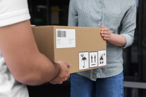 Woman Receiving Parcel Courier Outdoors Closeup — стоковое фото