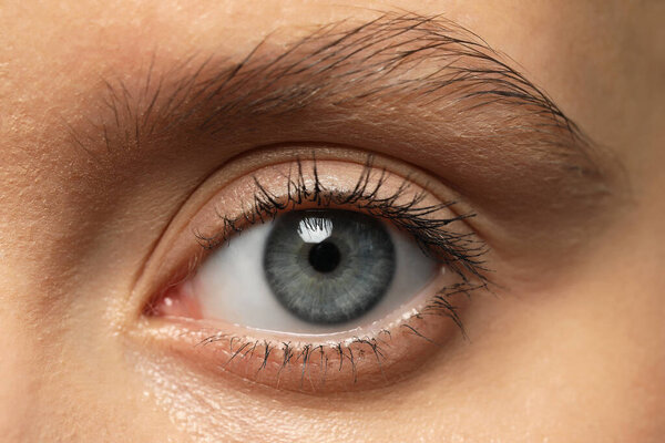 Beautiful woman with grey eye, closeup view