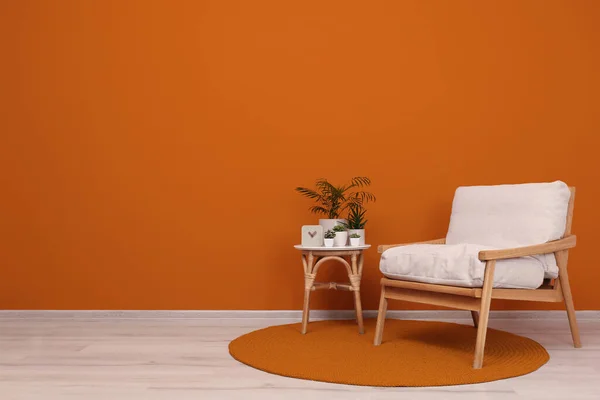 Stylish Room Interior Armchair Green Plants Orange Wall Space Text — 스톡 사진