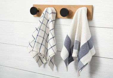 Different clean kitchen towels hanging on rack