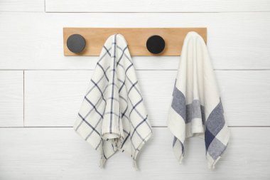 Different clean kitchen towels hanging on rack