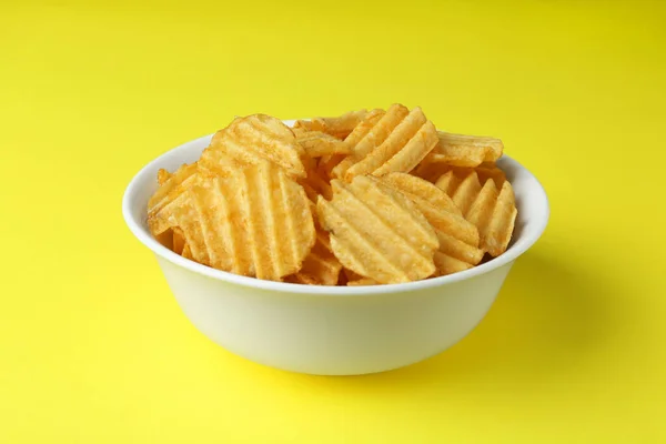 Bowl Tasty Ridged Potato Chips Yellow Background — Foto Stock