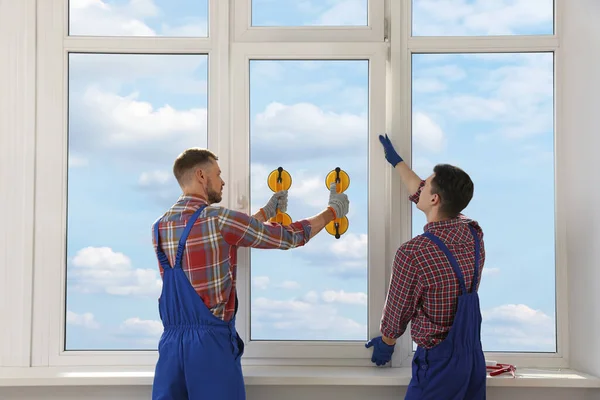 Workers Using Suction Lifters Plastic Window Installation Indoors — 스톡 사진