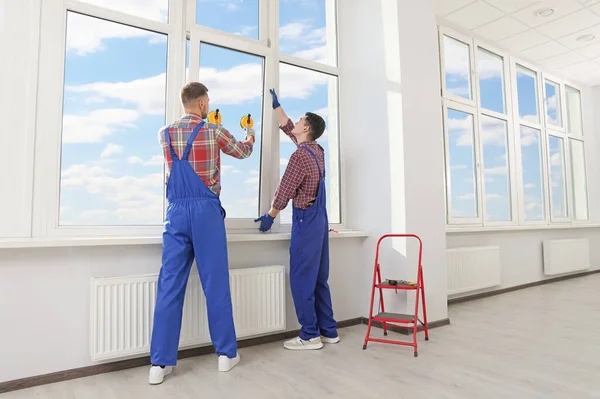 Workers Using Suction Lifters Plastic Window Installation Indoors — 스톡 사진