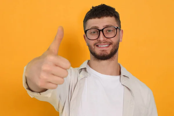 Young Man Showing Thumbs Orange Background — 图库照片