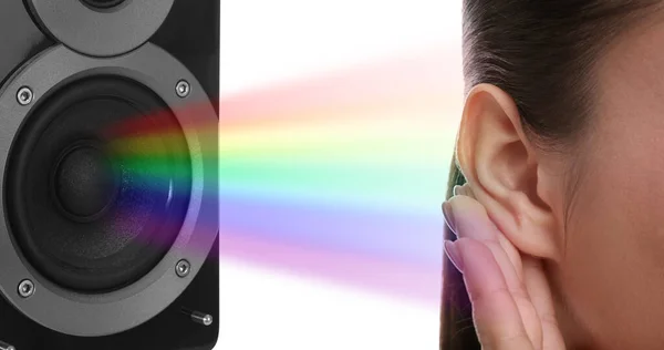Modern audio speaker and woman listening to music on white background, closeup view of ear. Banner design