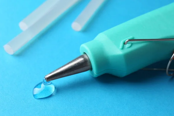 Melted Glue Dripping Out Hot Gun Nozzle Light Blue Background — Foto Stock