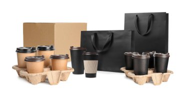 Set with cardboard box, takeaway cups and paper bags on white background