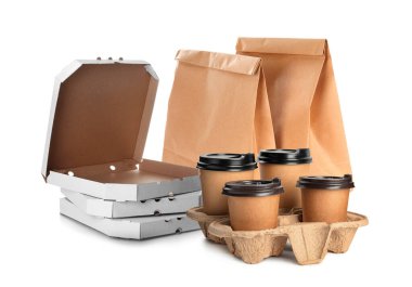 Set with cardboard pizza boxes, takeaway cups and paper bags on white background