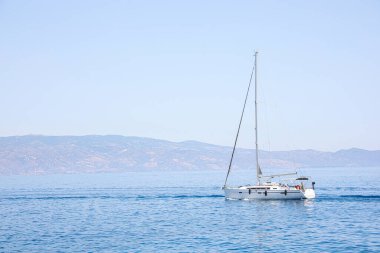 Beautiful seascape with sailboat and distant shore