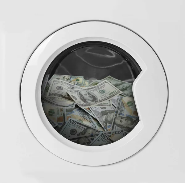 Money laundering. Many dollar banknotes in washing machine
