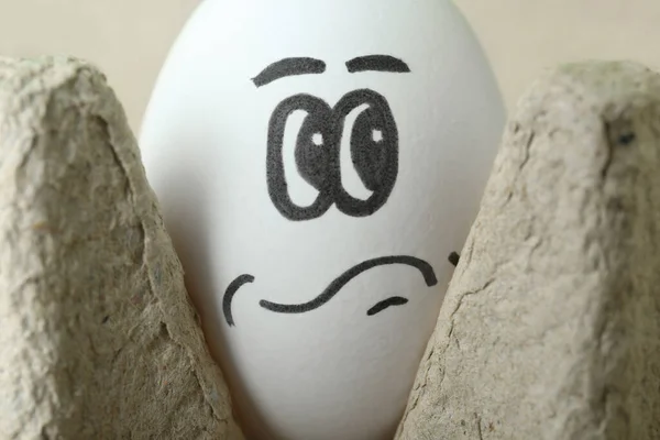 Egg Drawn Thoughtful Face Cardboard Package Closeup — Stockfoto