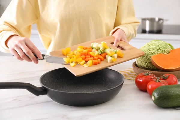 Woman Pouring Mix Cut Vegetables Frying Pan Table Kitchen Closeup —  Fotos de Stock