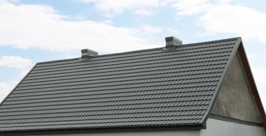 Modern building with grey roof outdoors on spring day