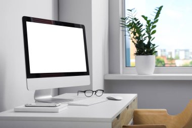 Workplace with modern computer and smartphone on white table. Mockup for design