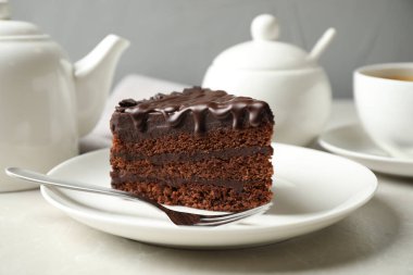 Tasty chocolate cake served on white table