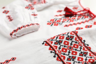 Beautiful white shirt with red Ukrainian national embroidery, closeup